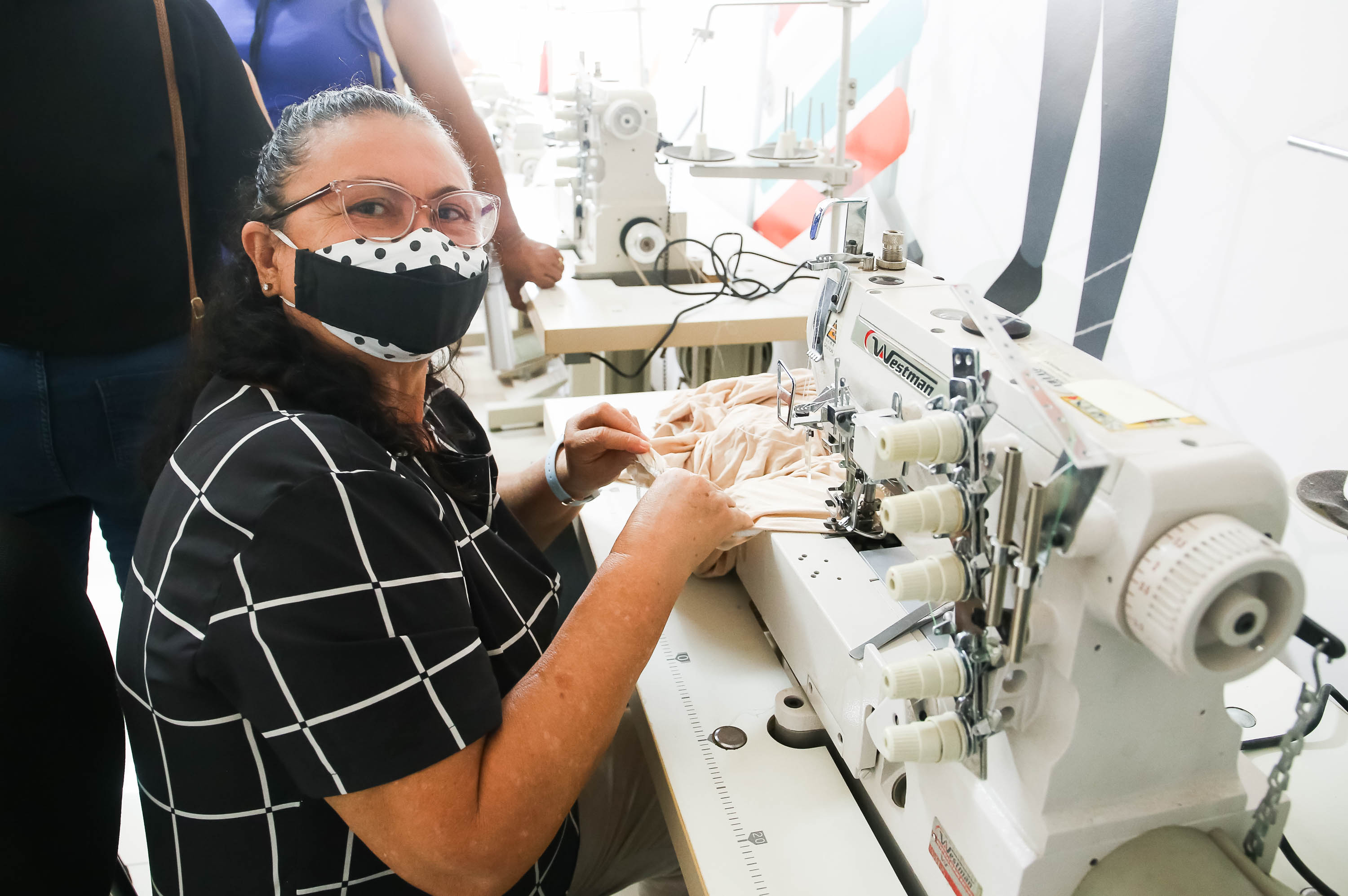 Expedita posa para a foto em uma máquina de costura